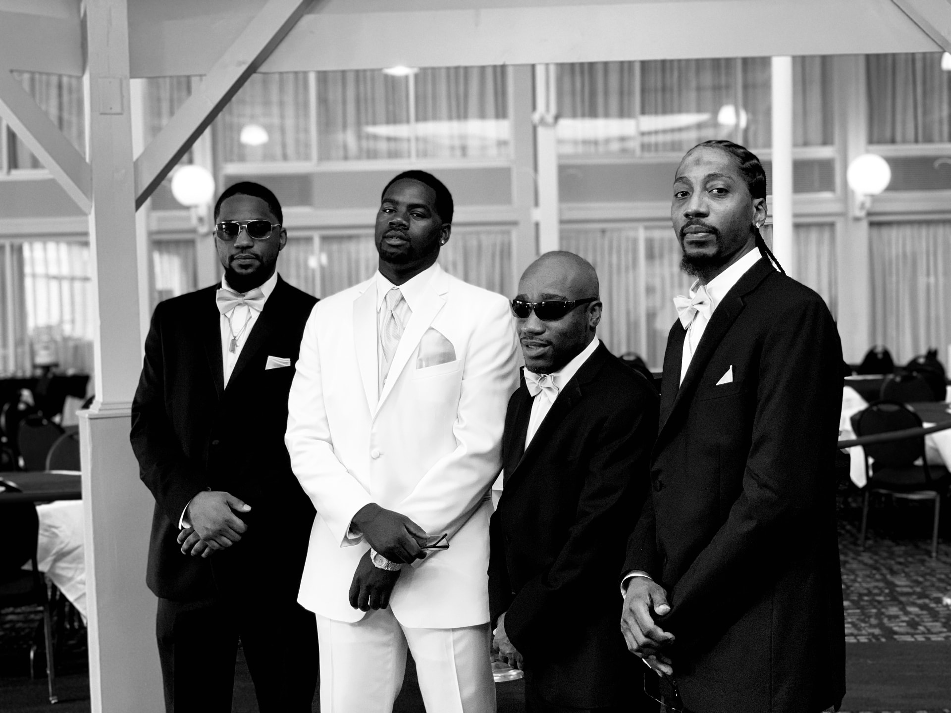 Black and white photograph of four men in formal dress